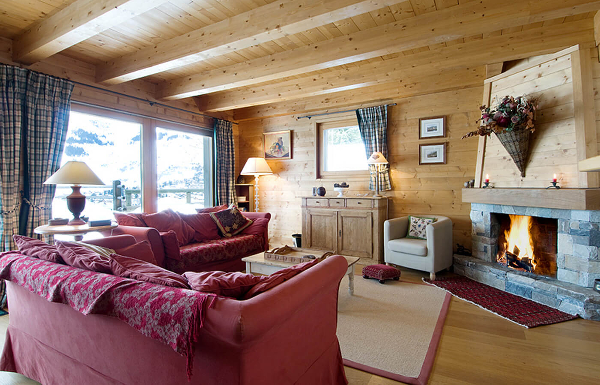 appartement-boissieres-027-verbier-salon-cheminee-canapes-rouges-01.jpg